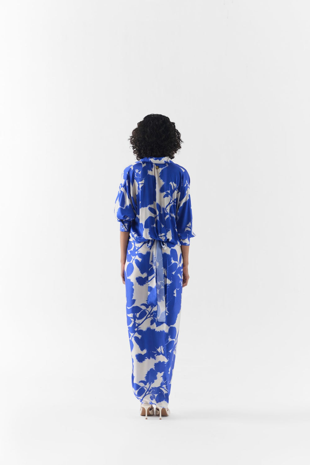 Side view of the Blue Ink Draped Shirt Dress highlighting its fluid drape